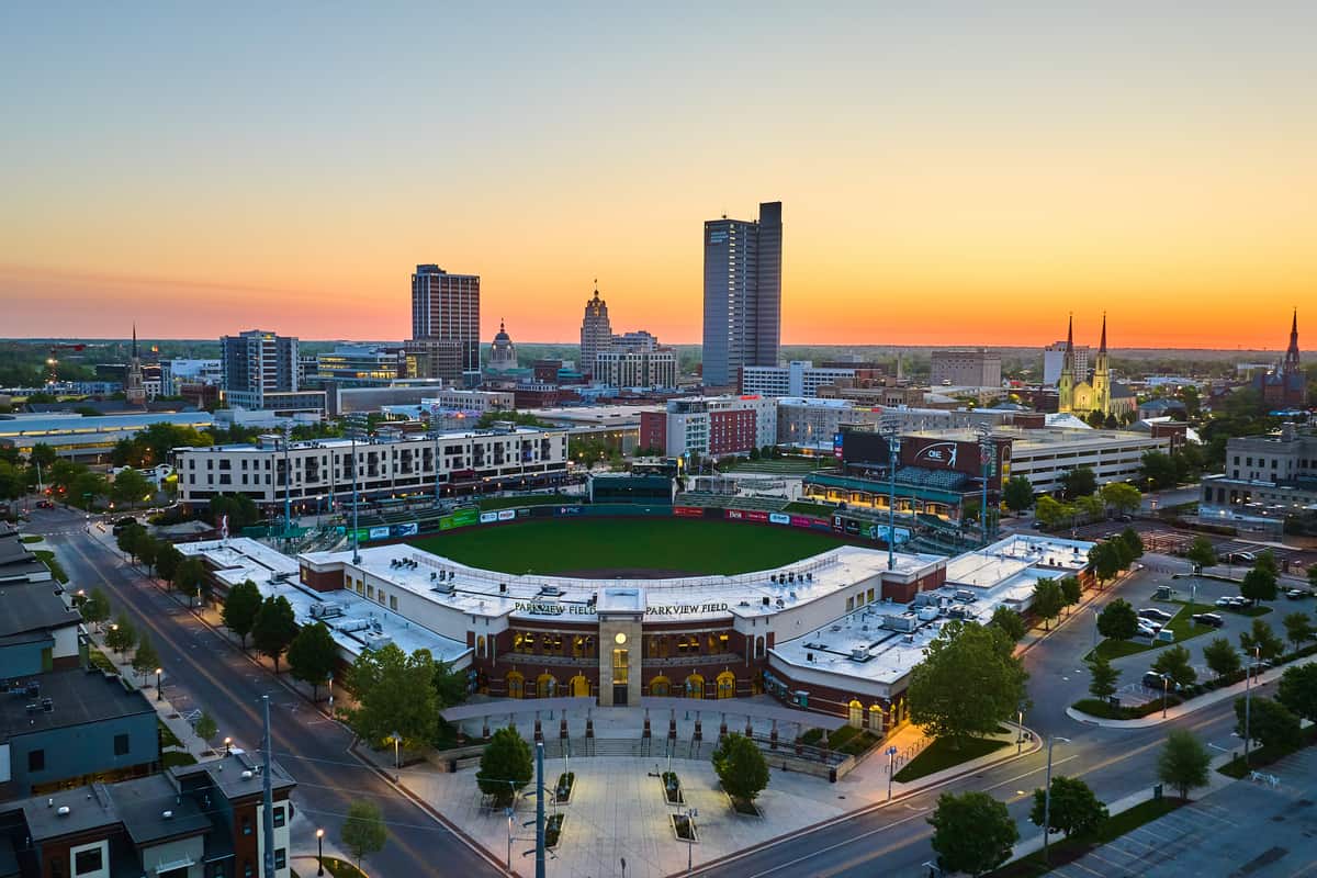 Parkview Field and downtown Fort Wayne, Indiana at sunset, with the Indiana Michigan Power Center and the rest of the skyline on the horizon behind the ballpark